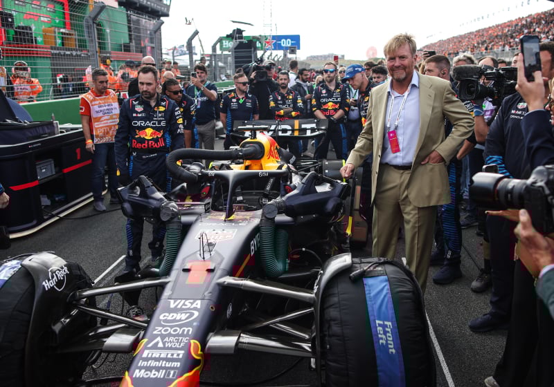 King Willem-Alexander posing with Verstappen's Red Bull