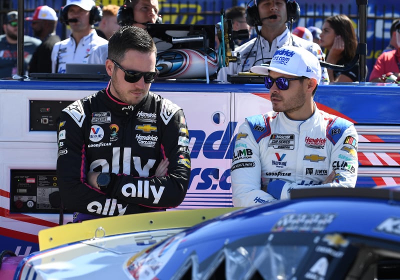 An image of Hendrick Motorsports drivers Alex Bowman and Kyle Larson looking disappointed