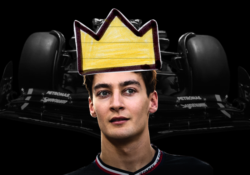 George Russell wears a crown in front of the Mercedes car