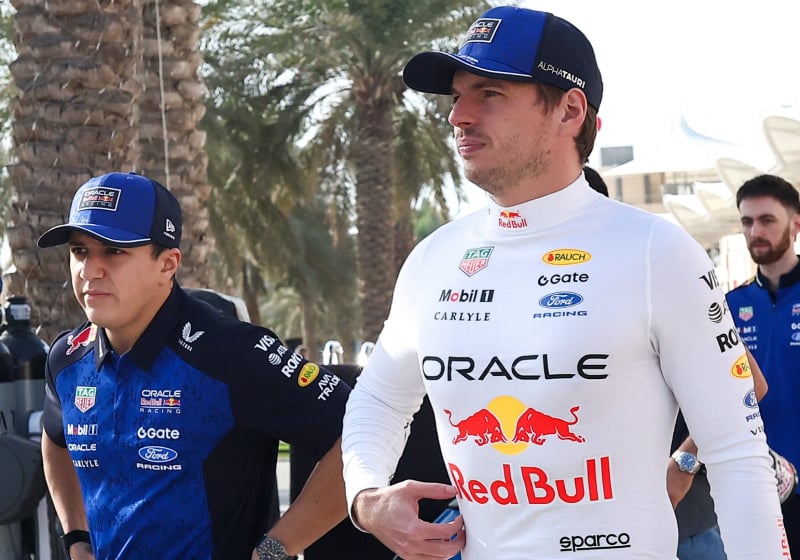 Max Verstappen and Isack Hadjar walking into the Bahrain paddock during pre season testing