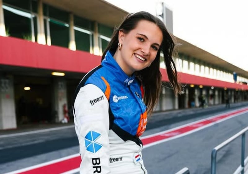Esmee Kosterman poses for a photo trackside in a racing suit