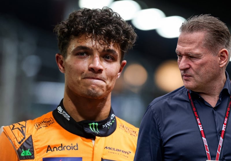Lando Norris looks sheepish as Jos Verstappen glances over at him