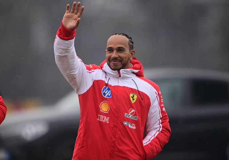Lewis Hamilton waves to the crowd at Ferrari's shakedown