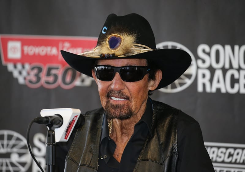 An image of NASCAR legend Richard Petty talking at a press conference