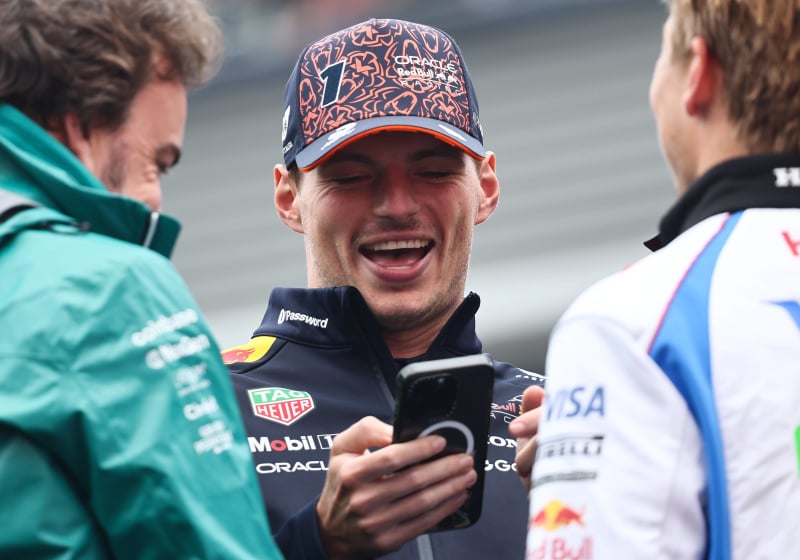 Verstappen laughs at his phone