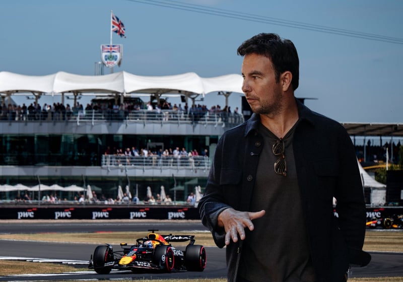 Sergio Perez in front of the Silverstone track as two Red Bulls drive behind him