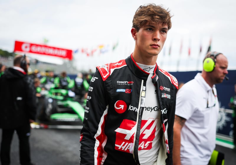 Ollie Berman looks concerned in a Haas race suit