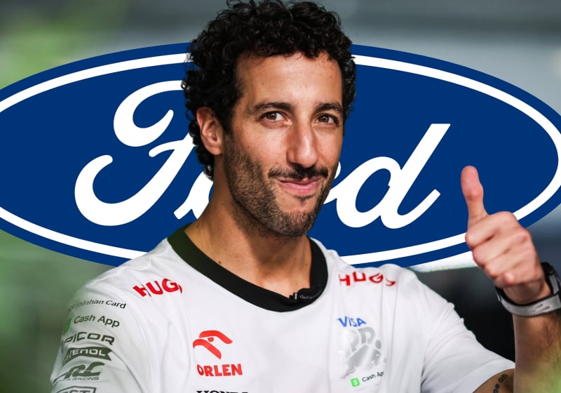 Daniel Ricciardo smiles and gives a thumbs up with the Ford logo in the background