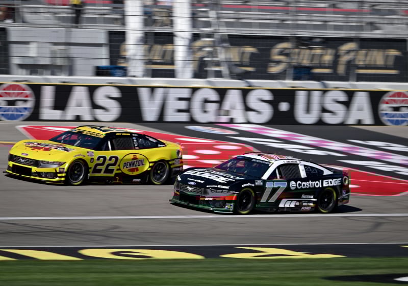 An image of two cars racing in the NASCAR Cup Series in Las Vegas