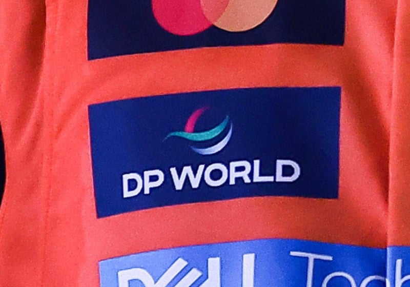 The DP World logo is seen on the McLaren racesuit