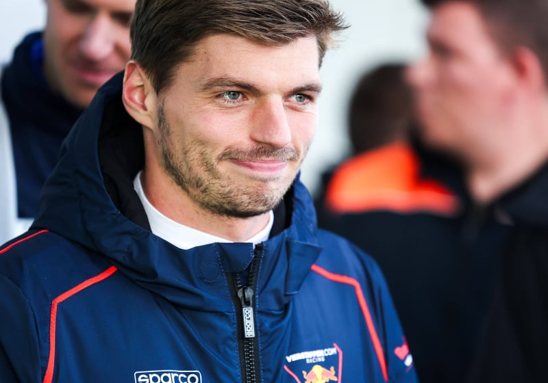 Verstappen smirking in a Verstappen.com jacket during his gt appearance at the Nurburgring