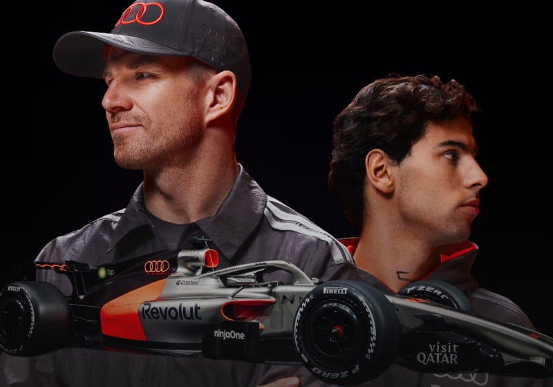 Gabriel Bortoleto and Nico Hulkenberg above the new Audi F1 car - Photo Credit Audi