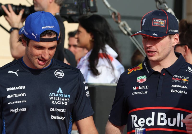 Carlos Sainz and Max Verstappen walking side by side in F1 paddock