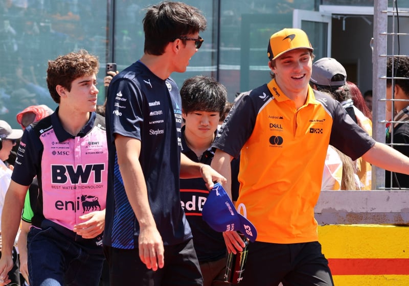 Colapinto, Tsunoda, Albon and Piastri walking in the F1 paddock