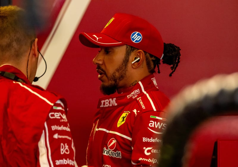 Lewis Hamilton in a Ferrari race suit in the Ferrari garage