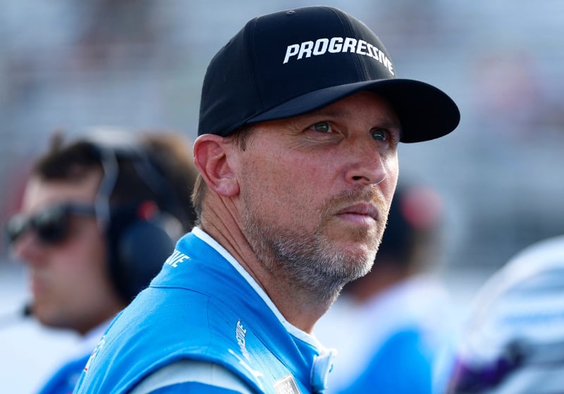 An image of NASCAR driver Denny Hamlin frowning and looking into the distance