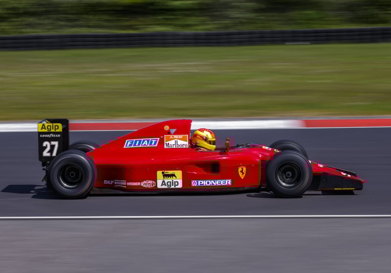 A 1992 Ferrari F1 car being driven around the Nurburgring track in 2023